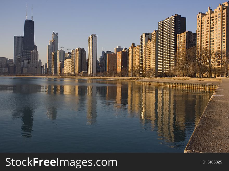 Hancock Tower and surrounding buildings reflected in Lake Michigan. Hancock Tower and surrounding buildings reflected in Lake Michigan.