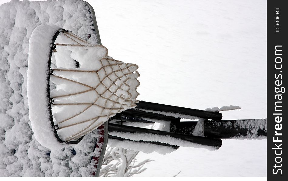 Basketball net, backboard and rim covered with snow. Basketball net, backboard and rim covered with snow.