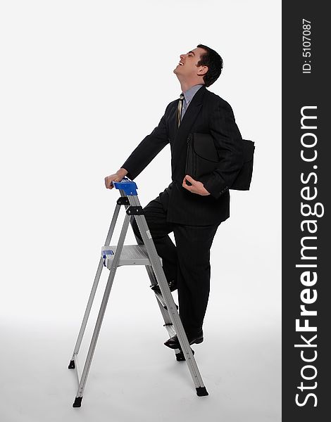 Businessman smiling as he climbs up a stepladder, briefcase in hand. Isolated against a white background. Businessman smiling as he climbs up a stepladder, briefcase in hand. Isolated against a white background