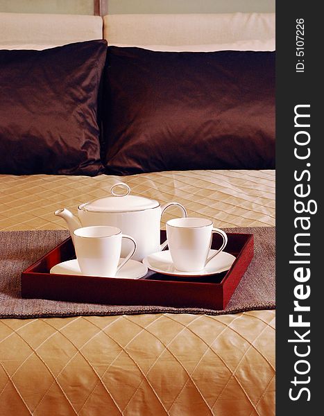 Tea Set on the bed of a posh room. Tea Set on the bed of a posh room