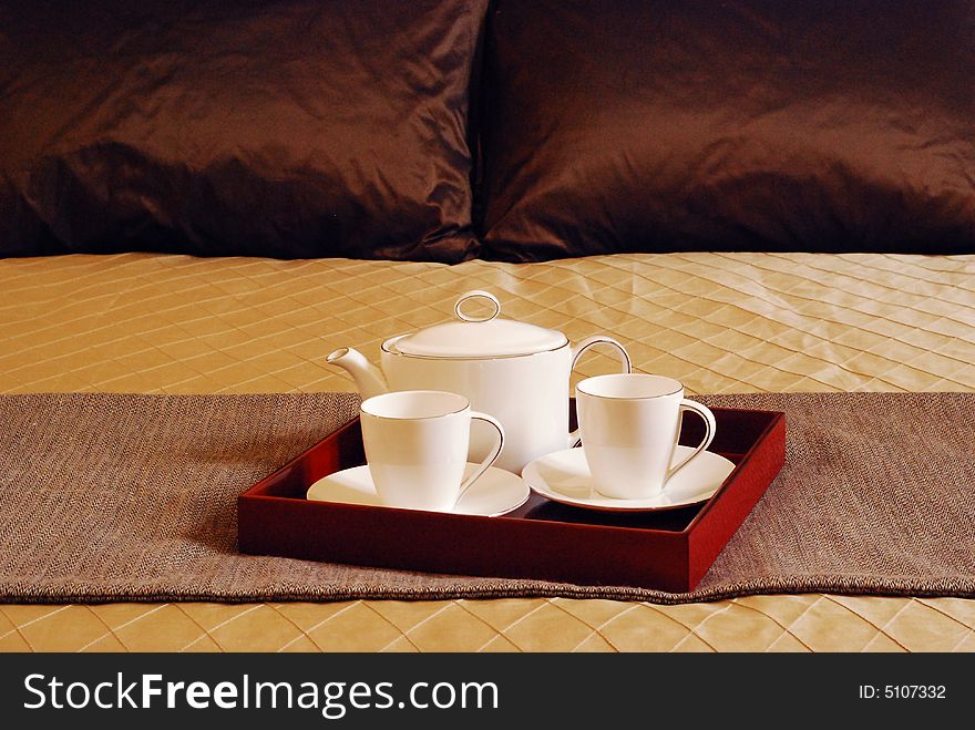 Tea Set on the bed of a posh room. Tea Set on the bed of a posh room