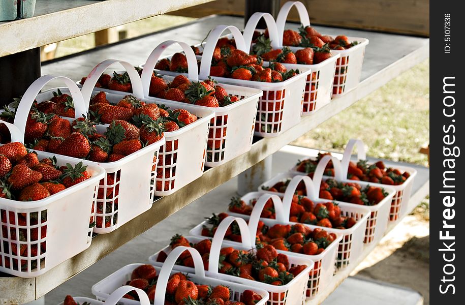 Fresh strawberries in baskets at a farmers market