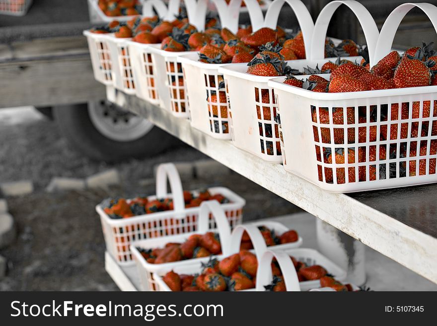 Fresh strawberries in baskets at a farmers market
