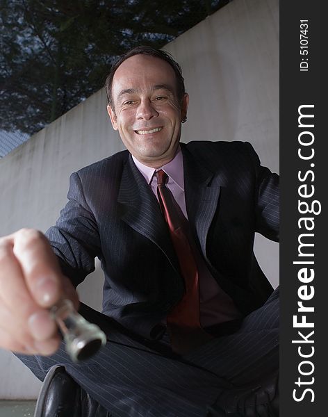 A close-up shot of a businessman playing with chess pieces, sitting cross-legged. A close-up shot of a businessman playing with chess pieces, sitting cross-legged.