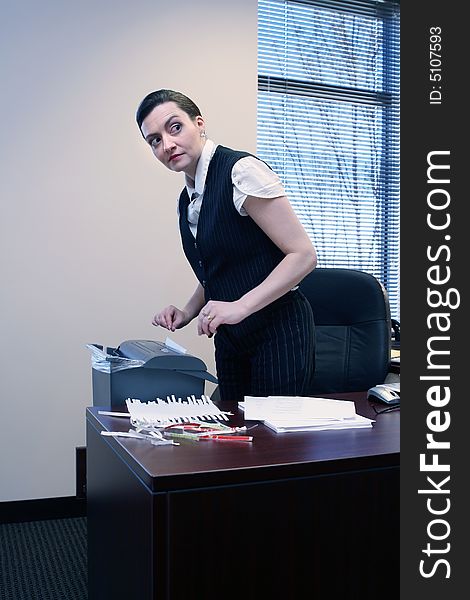 Businesswoman shredding documents at her desk
