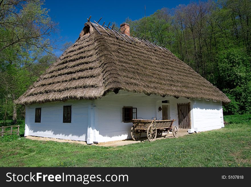 Very old Polish white hut with thatched roof. Very old Polish white hut with thatched roof