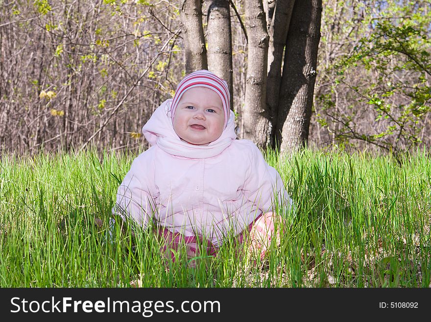 Smiling Baby On Green Grass