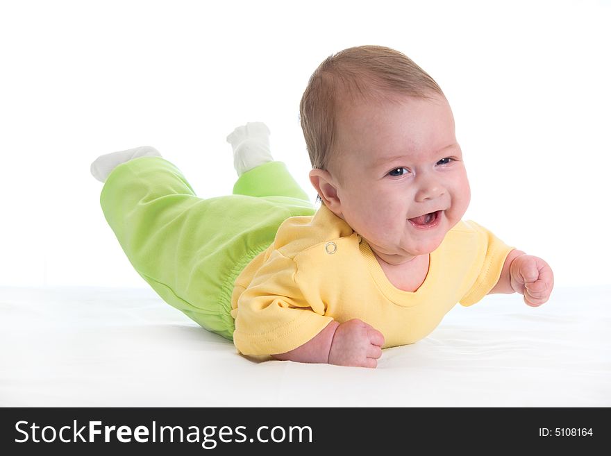 Smiling baby on bed over white