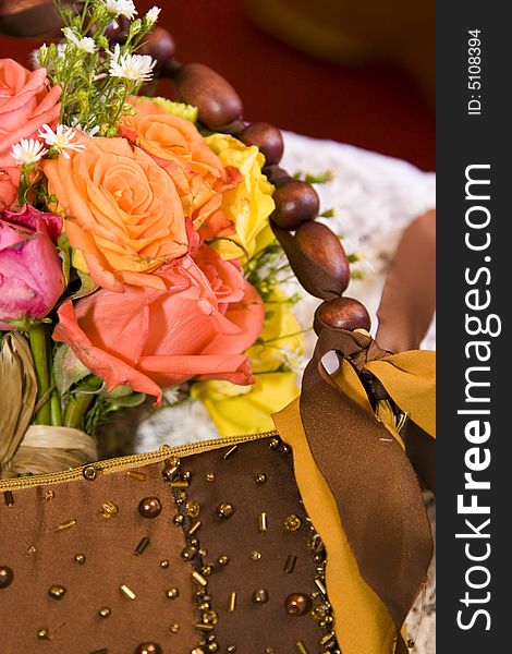 Rink, orange and yellow flowers and a brown hanbag. Rink, orange and yellow flowers and a brown hanbag