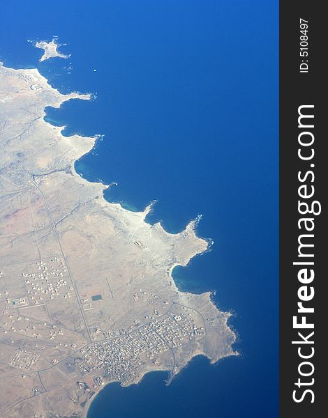 A view of land and ocean from the sky. A view of land and ocean from the sky