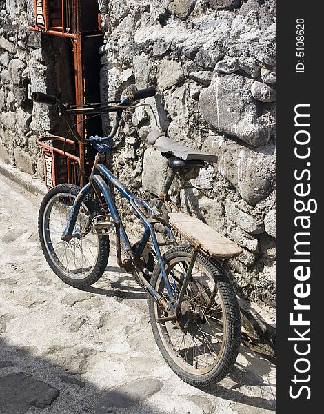 Bike propped up against a stone wall. Bike propped up against a stone wall