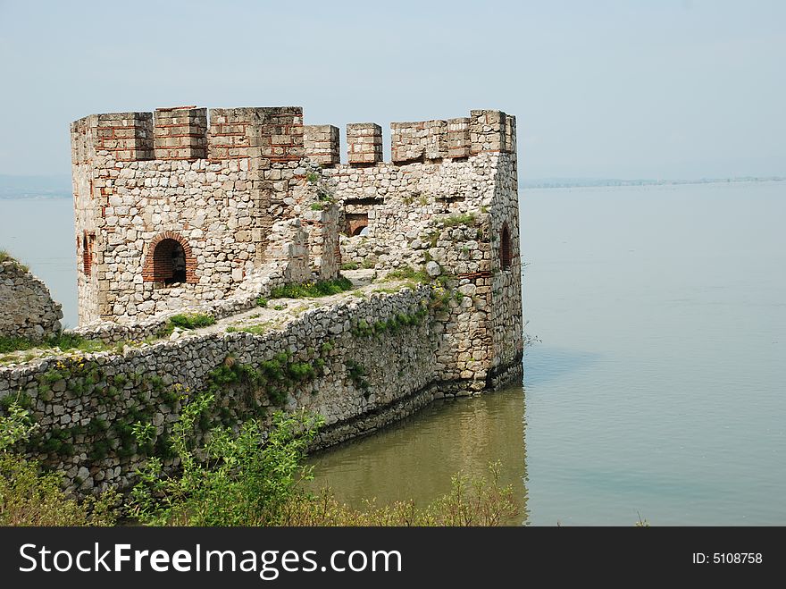 Old stone Serbian fortification on Danube tower in water