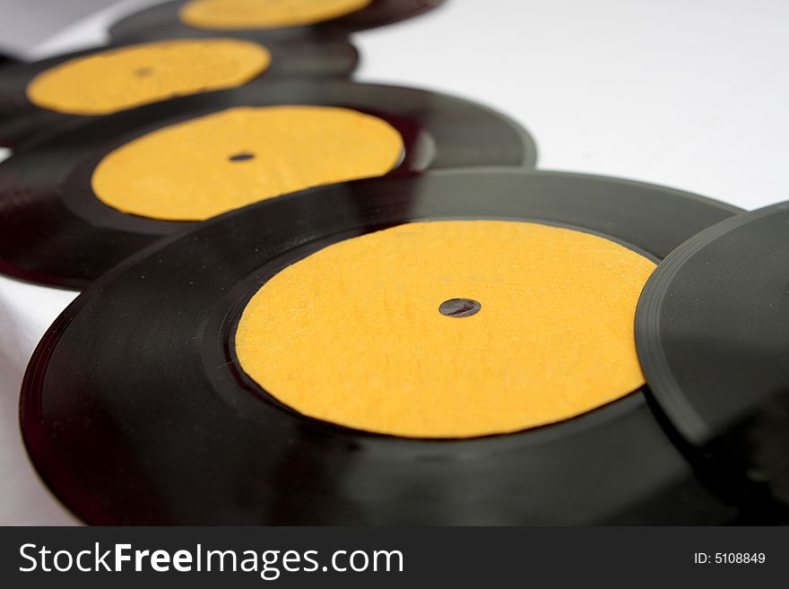 A bunch of old records on a table. A bunch of old records on a table