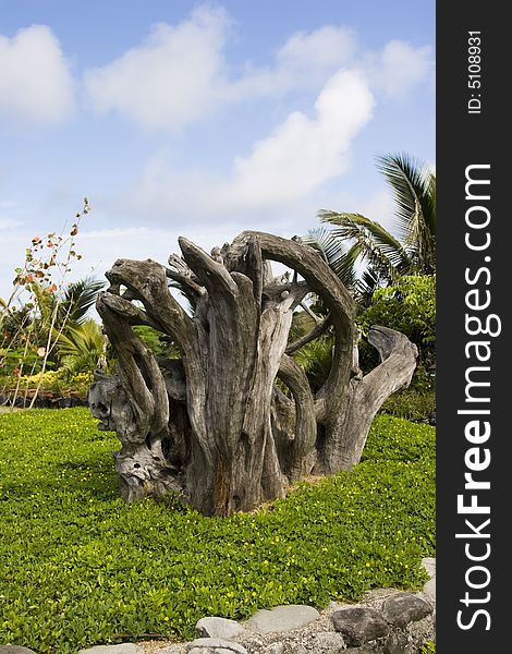 A wooden sculpture in the middle of a garden