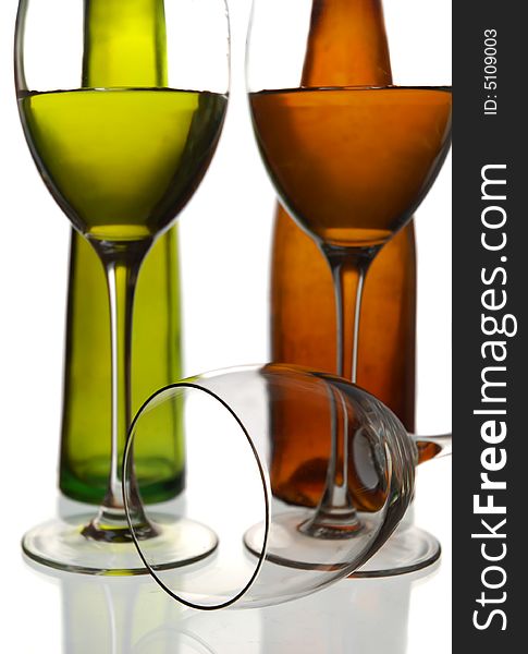 Wine bottles and two glasses with water against a white background. Wine bottles and two glasses with water against a white background