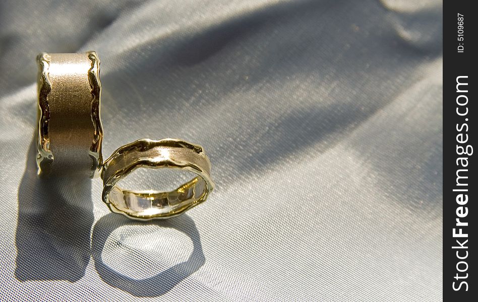 Beautiful unique wedding rings on a silk pillow. LO for love