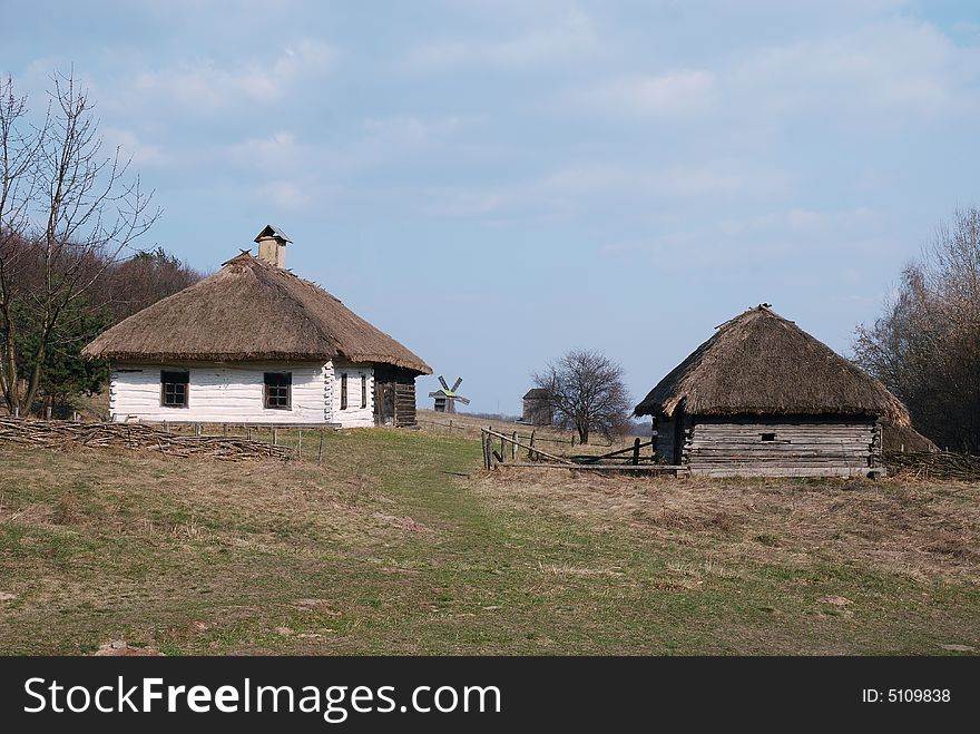 Old white loghouse thatched, museum