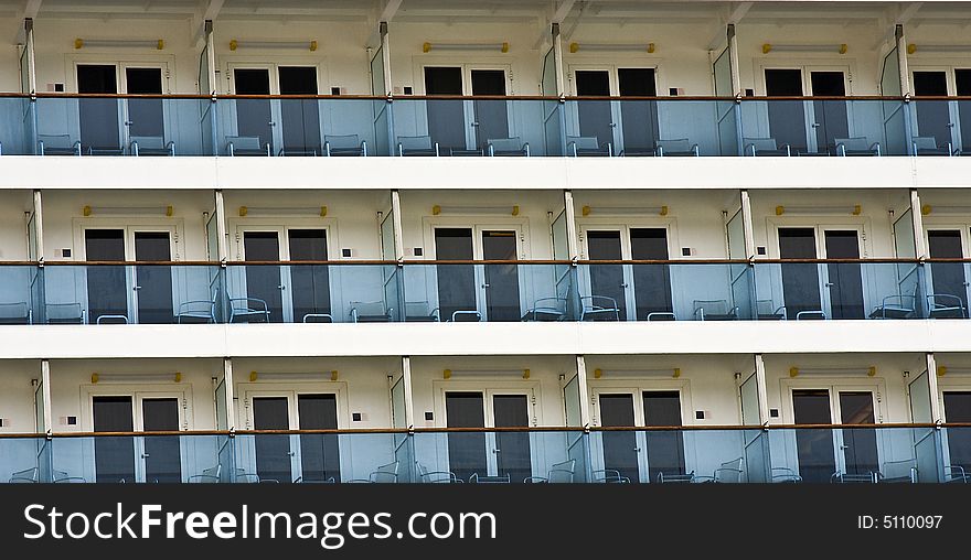 Several balconies on a cruise liner in the port.