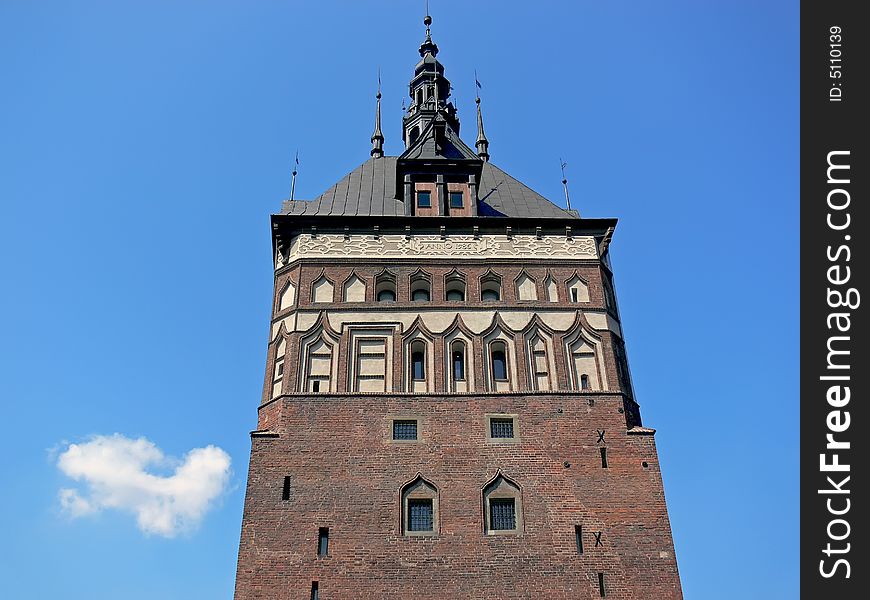 The historical building in Gdańsk, Poland. Red brick tower. The historical building in Gdańsk, Poland. Red brick tower.