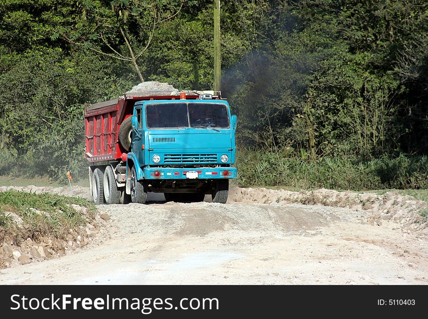 Blue Dump Truck on a country road