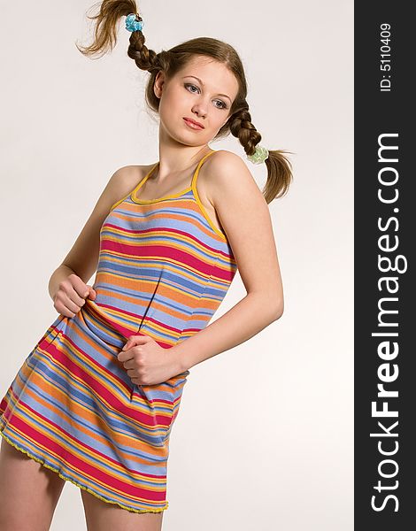 model with pigtails dressed rainbow-colored short dress. model with pigtails dressed rainbow-colored short dress
