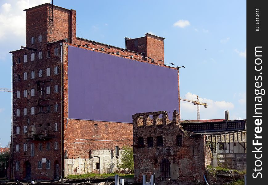 Old devastated buildings with big place for advertisement or banner.