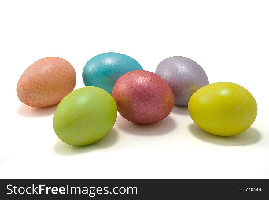 Six colored Easter eggs on white background