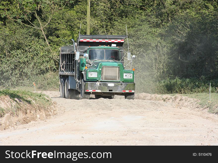 Truck transportin gravel on a country road. Truck transportin gravel on a country road