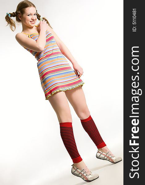 model with pigtails dressed rainbow-colored short dress. model with pigtails dressed rainbow-colored short dress