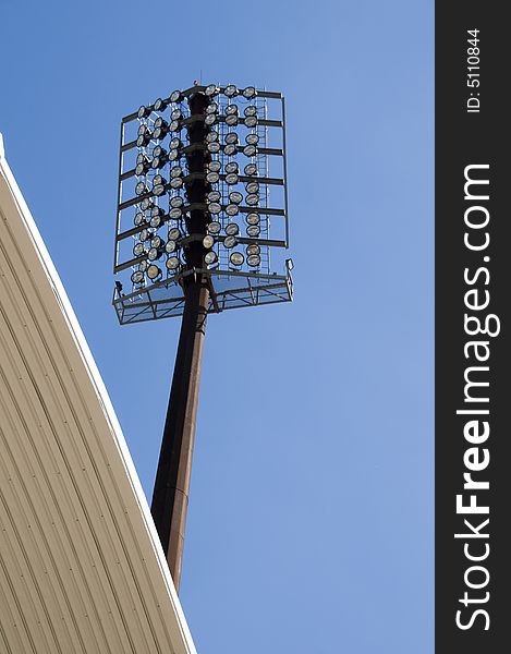 Stadium lights against a blue sky