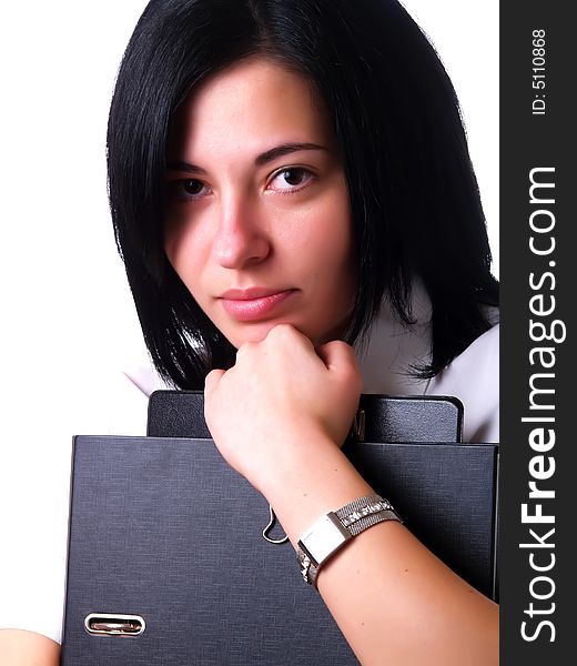 A portrait about a young pretty happy businesswoman with black hair who is holding some folders and she is wearing a white shirt. A portrait about a young pretty happy businesswoman with black hair who is holding some folders and she is wearing a white shirt