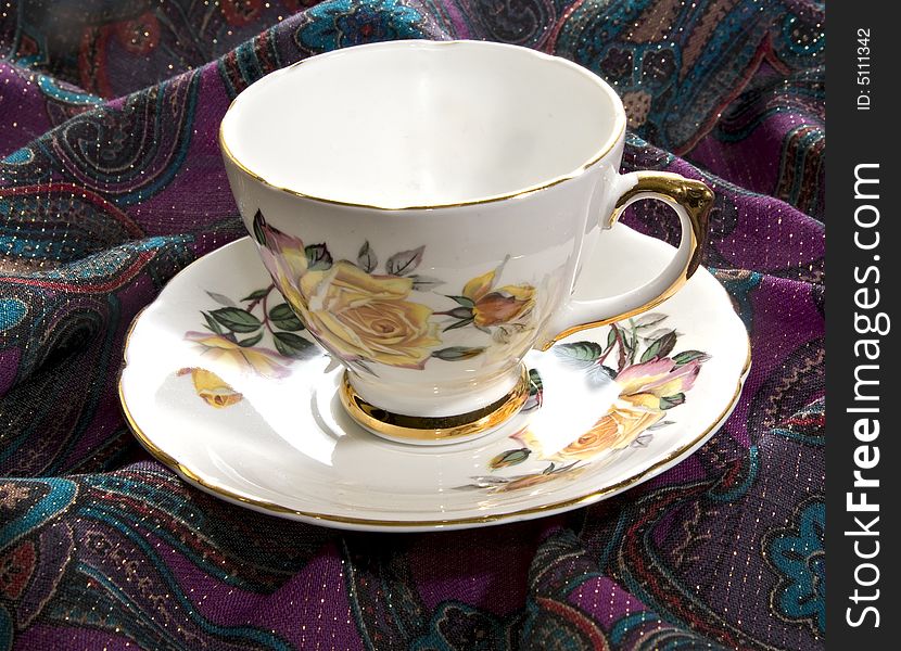 An old ornate tea cup and saucer with gold trim. An old ornate tea cup and saucer with gold trim.