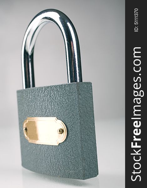 Metal padlock over grey