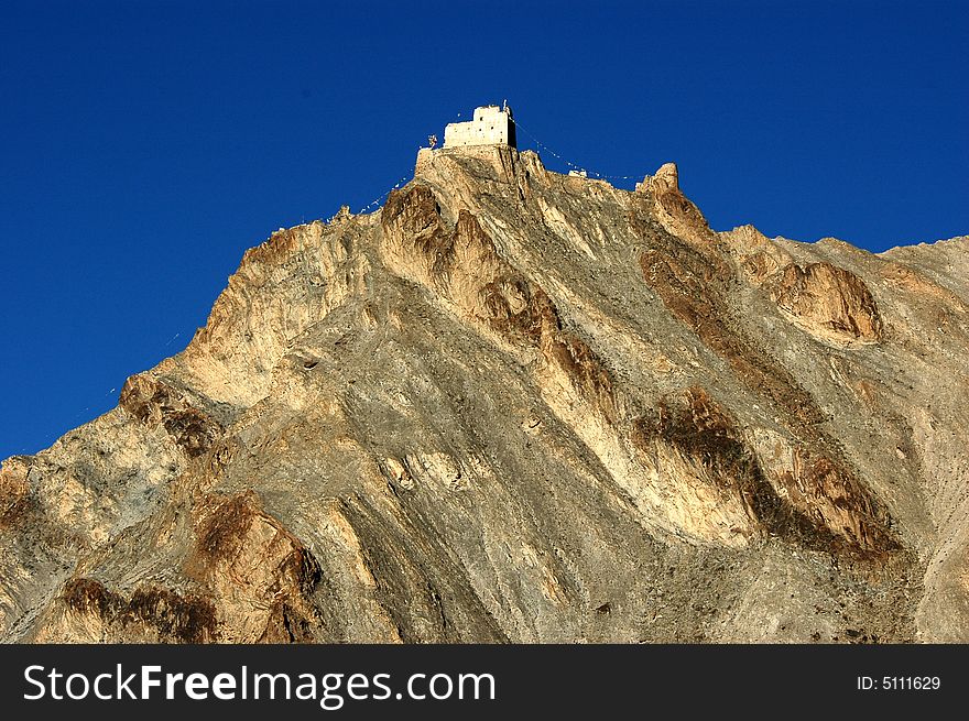 The Tibetan golden mountain in the morning sunshine, A castle on the top of it. The Tibetan golden mountain in the morning sunshine, A castle on the top of it.