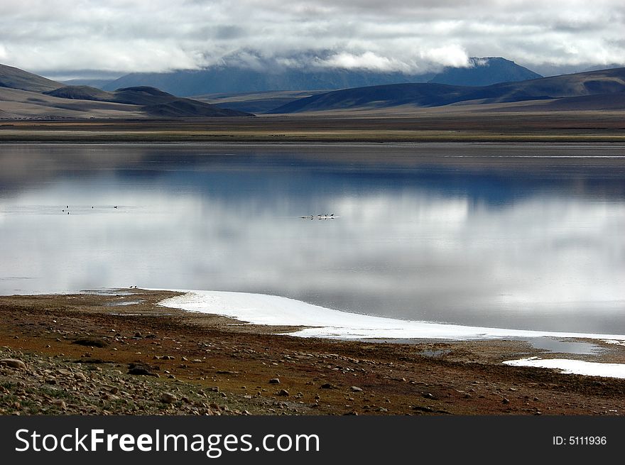 The sacred lake of Tibet,the Sheep Lake, reflecting the white clouds and blue sky. The sacred lake of Tibet,the Sheep Lake, reflecting the white clouds and blue sky.