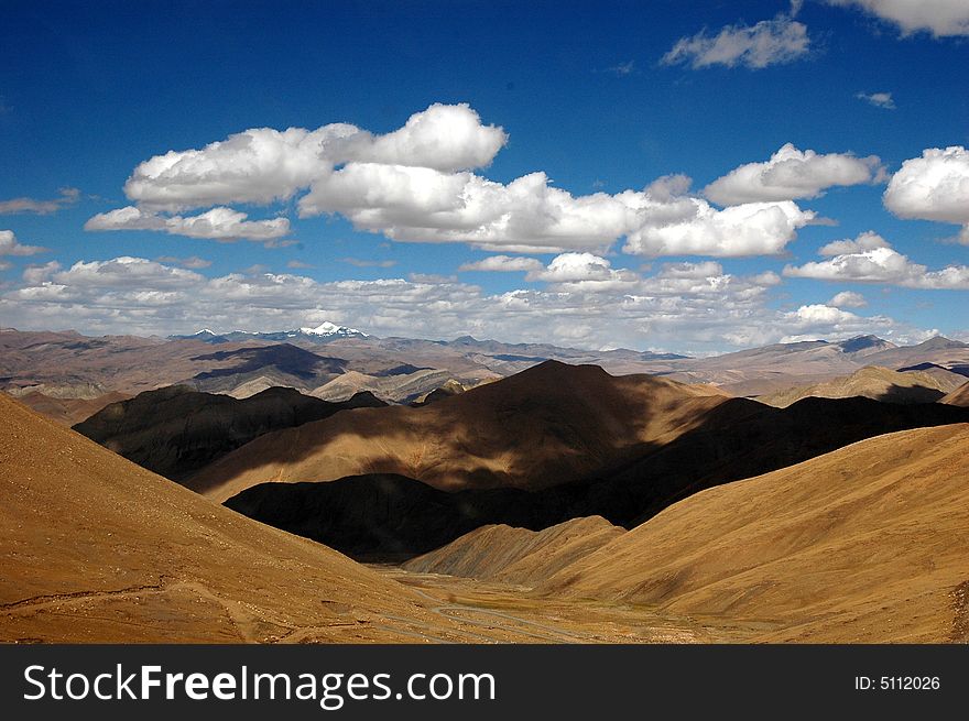The aerial view of the himalays mountains in the Tibet plateau,with pure blue sky and white clouds.