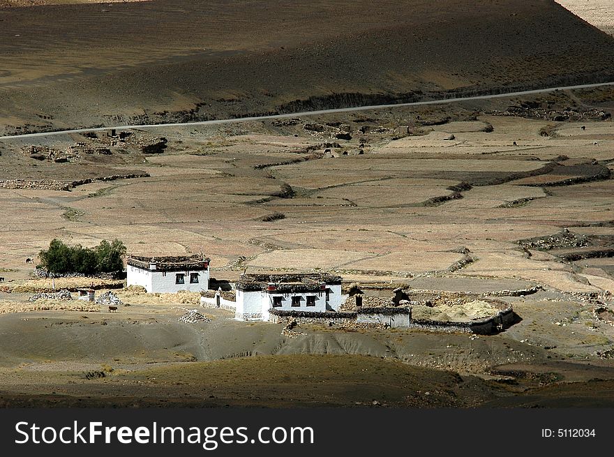 A small tibetan village in the middle of the pasture and field. A small tibetan village in the middle of the pasture and field.