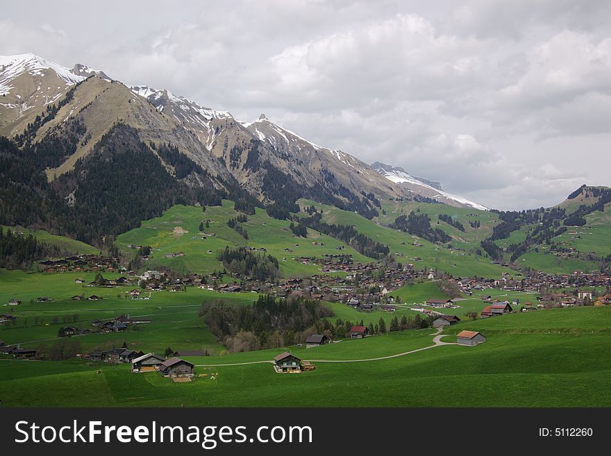 Mountain rural landscape, village in green slopes, Alps, Switzerland. Mountain rural landscape, village in green slopes, Alps, Switzerland.