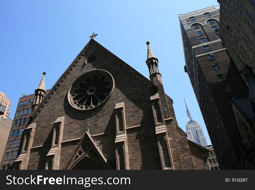 Church in Manhattan with the Empire State Building in the background. Church in Manhattan with the Empire State Building in the background.