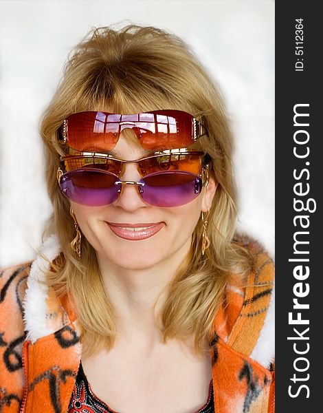 The woman in solar glasses smiles . The woman in solar glasses smiles .