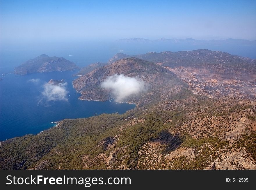 Aerial view on mountains, sea, sky and clouds. Aerial view on mountains, sea, sky and clouds