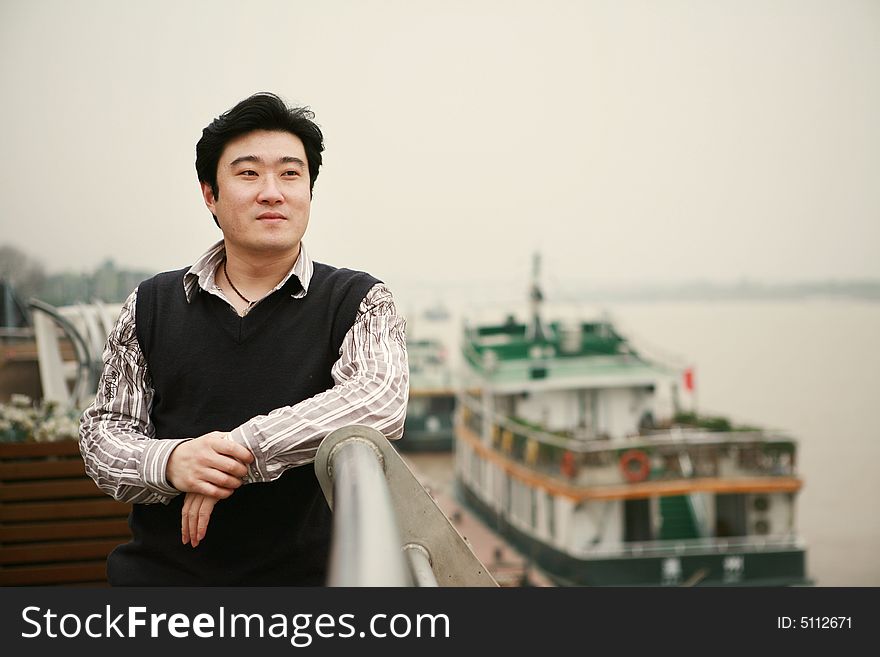 A young asian man beside aboard