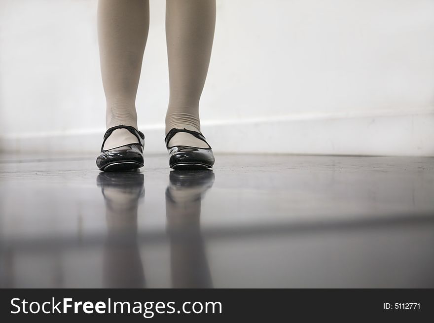 Young dancer in tap shoes... low angle shot of just feet and legs. Young dancer in tap shoes... low angle shot of just feet and legs