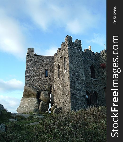 This is a medieval 14th century fortress built on top of rocks at the top of a hill at Carn Brea, Cornwall, England. It's amazing that it remains balanced precariously on the rocks. This is a medieval 14th century fortress built on top of rocks at the top of a hill at Carn Brea, Cornwall, England. It's amazing that it remains balanced precariously on the rocks.