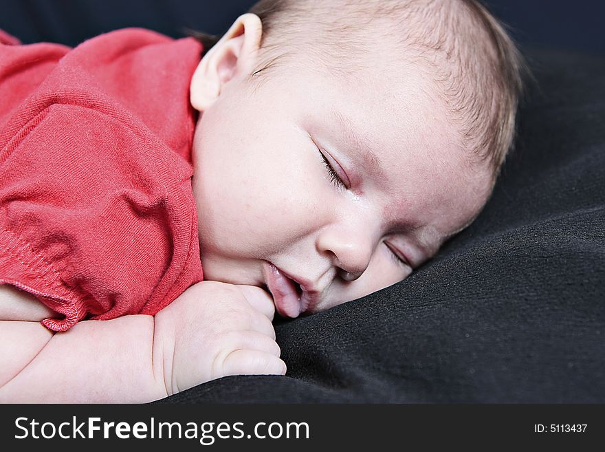 Newborn Baby sleeping on black Background