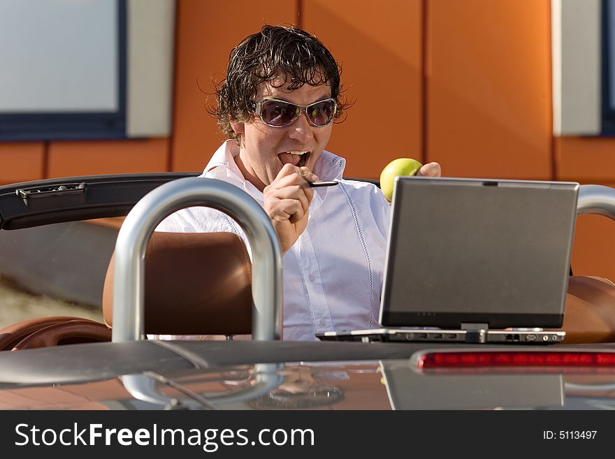 Man using a laptop outdoors. Man using a laptop outdoors