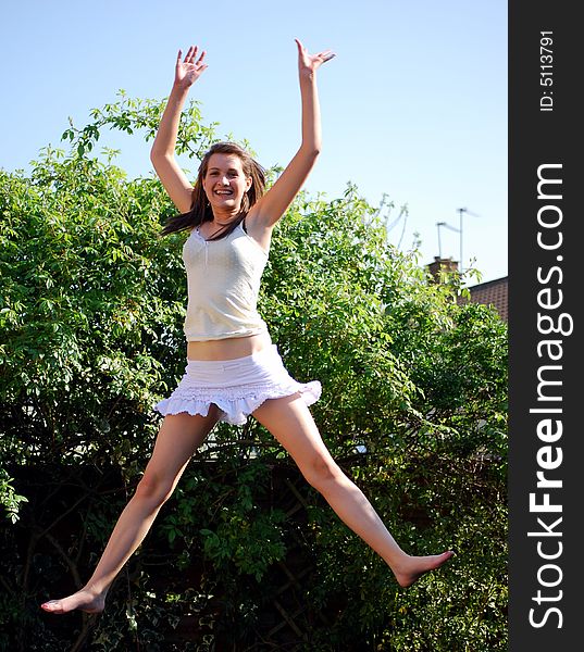 Shot of a teenage girl jumping in the air. Shot of a teenage girl jumping in the air