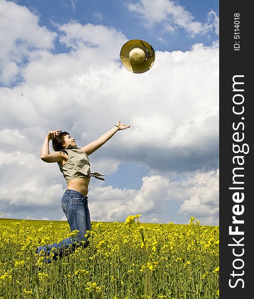 Young attractive girl jumping in spring rape field. Young attractive girl jumping in spring rape field