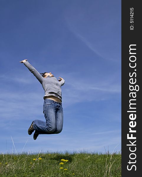 Young attractive girl jumping against blue sky. Young attractive girl jumping against blue sky