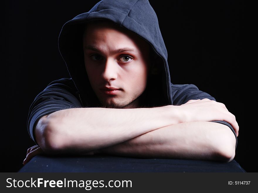 Fashion portrait of young man at black background. Fashion portrait of young man at black background